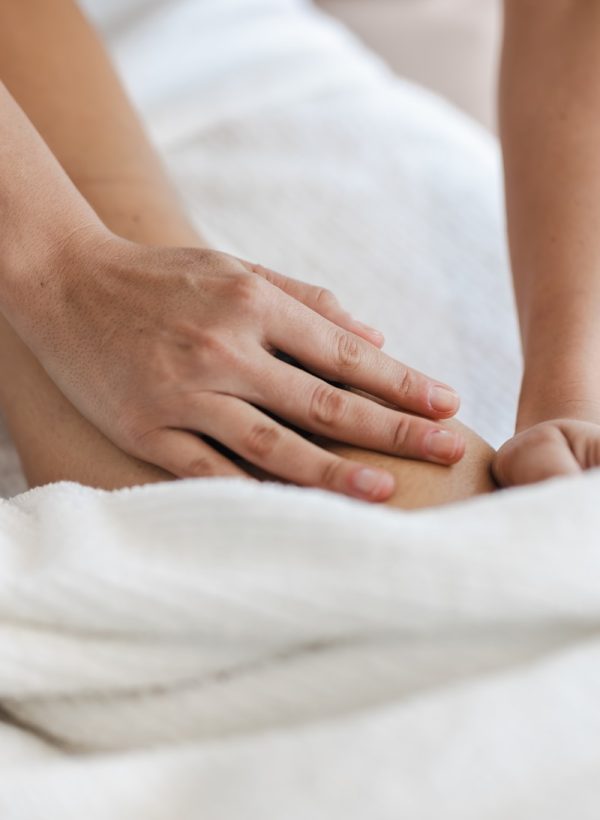 a close up of a person laying in a bed with a towel